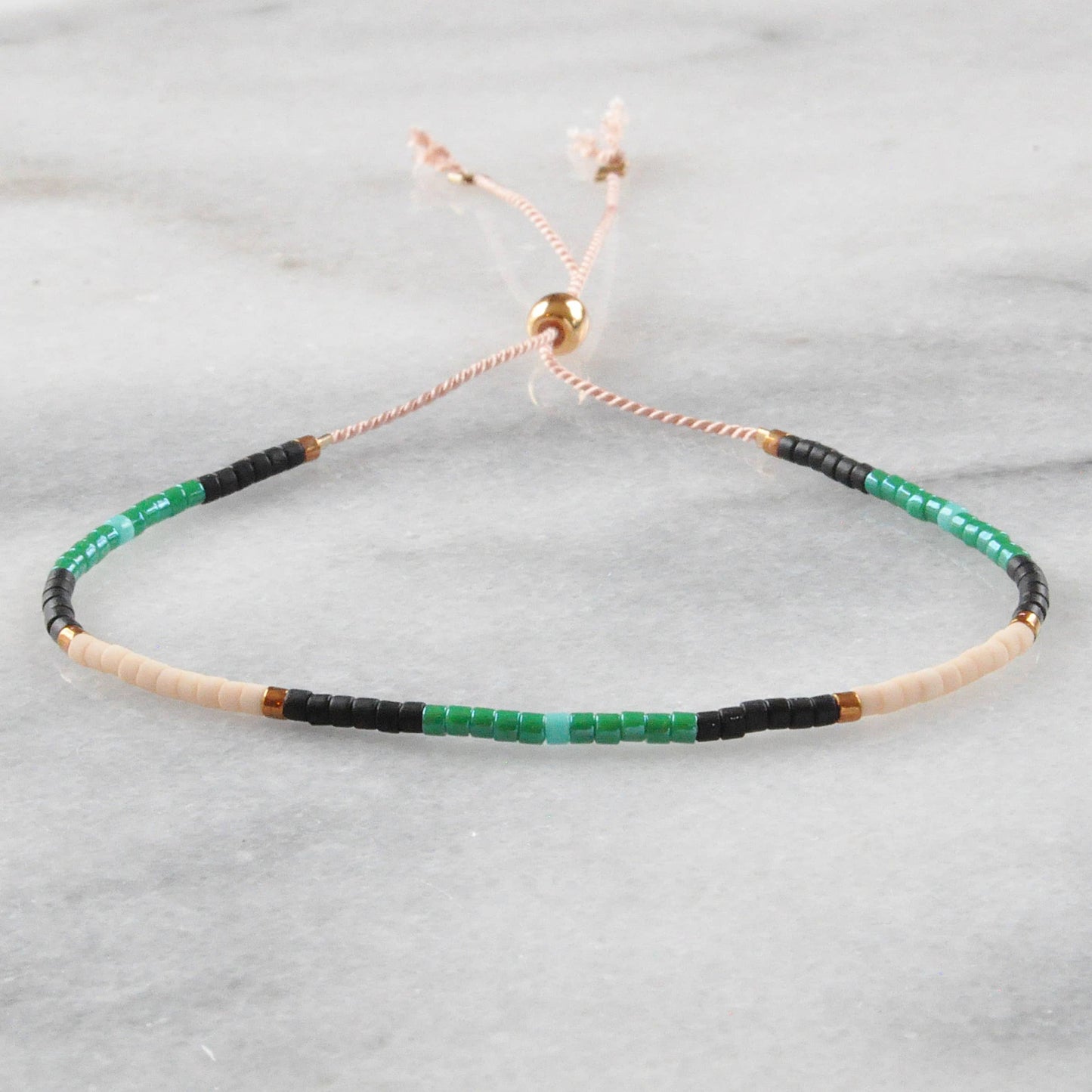 Handmade Adjustable Seed Bead String Bracelet
• Flora Black & Emerald